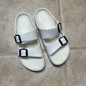 White plastic slip ons
